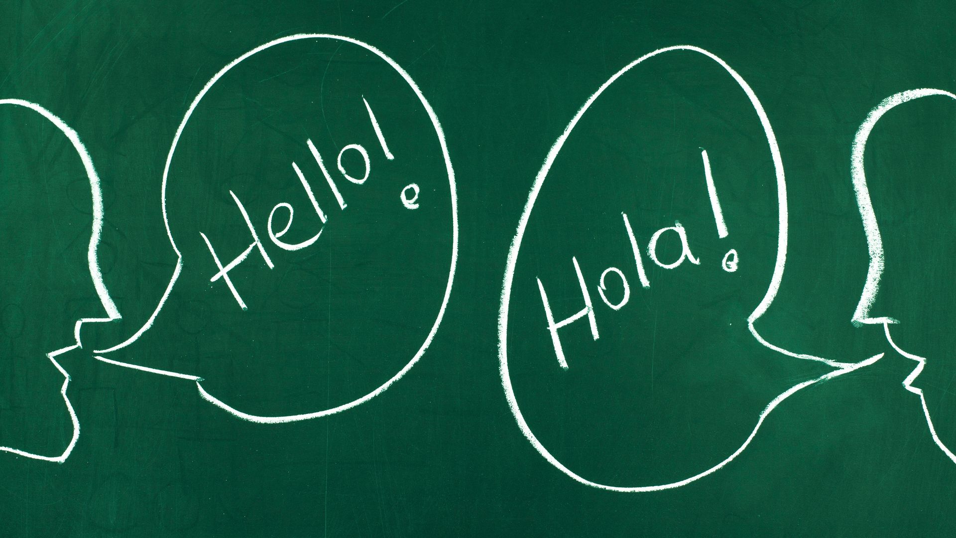 A chalk drawing of two speech bubbles with the words hello, hola, and